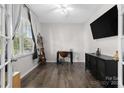 Bright home office features hardwood floors, a large window with blinds, and a modern black desk and chair at 2042 Newport Dr, Fort Mill, SC 29707