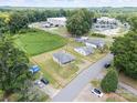 Aerial view showcasing two single-story homes with a spacious grassy lot outlined in yellow at 206 13Th St, Belmont, NC 28012