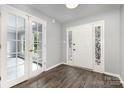 Bright foyer with hardwood floors, stained-glass-accented front door, and French doors leading to another room at 2112 Flint Glenn Ln, Charlotte, NC 28262