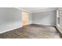 Spacious living room with modern wood-look flooring, neutral paint, and ample natural light at 2112 Flint Glenn Ln, Charlotte, NC 28262
