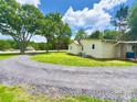 Scenic property view with gravel driveway leading to a cozy, well-maintained house at 2482 E Nc 10 Hwy, Conover, NC 28613