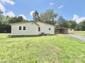 Rear view of the house showcasing a well-kept lawn and detached structure at 2482 E Nc 10 Hwy, Conover, NC 28613