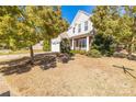 Beautiful home with mature trees, a well-manicured lawn, and a welcoming front porch at 2802 Azalea Hills Dr, Charlotte, NC 28262
