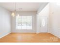 Bright and airy living room featuring wood floors, a large window, and neutral paint colors at 2802 Azalea Hills Dr, Charlotte, NC 28262