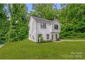 Attractive two-story home with lush green lawn, landscaping, and welcoming entrance at 2908 Burgess Dr, Charlotte, NC 28208