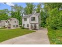 Beautiful two-story home featuring modern architecture, long driveway, and landscaped yard at 2908 Burgess Dr, Charlotte, NC 28208