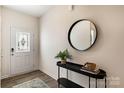 Inviting entryway with stylish decor, a decorative mirror, and hardwood floors, creating a warm welcome at 3019 Sassafras Trl, Gastonia, NC 28056