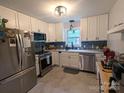 Modern kitchen boasts stainless steel appliances, sleek cabinetry, and stylish backsplash for contemporary appeal at 3116 Pilgrim Rd, Chester, SC 29706