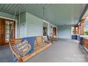 Inviting front porch featuring a swing, rocking chairs, and detailed woodwork, creating a cozy outdoor space at 319 S Oakland St, Gastonia, NC 28052