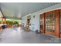 Inviting front porch featuring a swing, rocking chairs, and detailed woodwork, creating a cozy outdoor space at 319 S Oakland St, Gastonia, NC 28052
