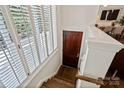 Charming entryway with hardwood floors, wooden door, window with white shutters, and natural light at 400 N Church St # 226, Charlotte, NC 28202
