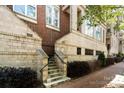 Charming brick condo entrance with inviting stairs and manicured landscaping, creating a warm and welcoming appeal at 400 N Church St # 226, Charlotte, NC 28202