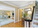 Elegant foyer with hardwood floors, stylish decor, and open doorways to the living room, enhancing the home's flow at 5508 Kincross Ln, Charlotte, NC 28277