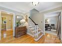 Charming foyer with hardwood floors, decorative mirror, and staircase, seamlessly connecting to other living spaces at 5508 Kincross Ln, Charlotte, NC 28277
