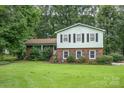 Charming two-story home featuring a brick facade, light green siding, and a well-manicured lawn at 5772 Gettysburg Nw Dr, Concord, NC 28027