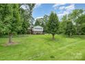 Well-maintained exterior with a lush lawn and mature trees surrounding a charming two-story home at 5772 Gettysburg Nw Dr, Concord, NC 28027