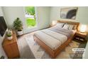 Cozy staged bedroom featuring a stylish bed, matching nightstands, and a bright window at 6041 Misty Way Ln, Charlotte, NC 28212