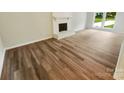 Bright living room showcases beautiful floors, a white fireplace, and lots of light at 6041 Misty Way Ln, Charlotte, NC 28212