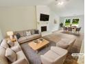 Bright, staged living room features modern furniture, fireplace, and ample natural light at 6041 Misty Way Ln, Charlotte, NC 28212