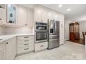 Well-appointed kitchen with stainless steel appliances, white cabinetry, and sleek countertops, offering a modern and functional space at 64 Timberidge Dr, Lake Wylie, SC 29710