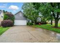 Gray home with a two-car garage, driveway, and well-kept lawn at 6717 Bickham Ln, Charlotte, NC 28269
