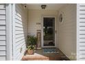 Cozy front porch featuring welcoming decor, enhancing curb appeal and inviting entry at 7122 Marlin St, Gastonia, NC 28056