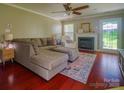 Inviting living room with a fireplace, comfortable seating, and warm hardwood floors at 7122 Marlin St, Gastonia, NC 28056