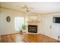 Cozy living room featuring wood-look floors, a fireplace, ceiling fan, and neutral walls at 745 Rock Castle Dr, York, SC 29745