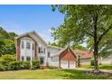 Beautiful two-story home featuring a brick and siding exterior, a spacious lawn, and a two-car garage at 8709 Huntland Ct, Charlotte, NC 28277
