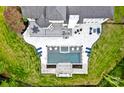 Aerial view showcasing the backyard oasis with a pool, spa, patio, outdoor kitchen, and lush landscaping at 1001 Berwick Ct, Waxhaw, NC 28173