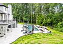 Expansive backyard featuring a luxurious pool, spa, outdoor kitchen, and a spacious deck for relaxation at 1001 Berwick Ct, Waxhaw, NC 28173