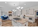 Bright kitchen with granite countertops, stainless appliances, and an island cooktop, open to the living room at 1001 Berwick Ct, Waxhaw, NC 28173