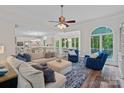 Open-concept living room featuring hardwood floors, neutral paint, a large arched window and an eat-in kitchen at 1001 Berwick Ct, Waxhaw, NC 28173