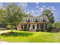 Traditional brick home with manicured lawn, dormer windows, and inviting entrance at 1208 Chausley Ct, Charlotte, NC 28211