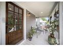 Inviting front porch featuring a glass door, seating area, and natural light at 131 Swink Sw St, Concord, NC 28027