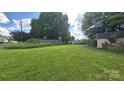Expansive backyard showcasing a lush green lawn and a peaceful setting, ideal for outdoor activities at 1313 Maiden E Rd, Maiden, NC 28650
