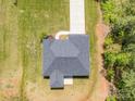 An aerial view of a charming home with a well-maintained lawn and lengthy driveway at 142 Highland Dr, New London, NC 28127