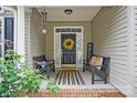Inviting front porch area with comfortable seating, a decorative wreath, and a welcoming ambiance at 146 Burtons Barn Rd, Mooresville, NC 28115