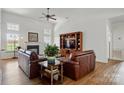 Cozy living room with fireplace, built-in shelving, and hardwood floors at 146 Burtons Barn Rd, Mooresville, NC 28115