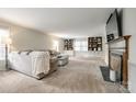 Spacious living room with built-in bookshelves, a fireplace, and a comfortable couch with a throw blanket at 1581 Granville Rd, Rock Hill, SC 29732