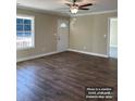 Bright living room with hardwood floors, large window, and neutral color palette, perfect for relaxation at 1669 California Rd, York, SC 29745