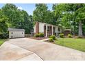 This home is framed by mature trees and lush landscaping and offers a detached garage at 206 Pelham Ln, Fort Mill, SC 29715