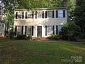 Inviting two-story home with black shutters and well-manicured lawn, offering classic charm and curb appeal at 2105 Killarney Pl, Charlotte, NC 28262