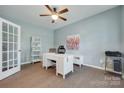 Bright home office with hardwood floors, ceiling fan, and a white contemporary desk at 217 Barberry Dr, Belmont, NC 28012