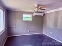 This bedroom features neutral-toned walls, ceiling fan, and a window for natural light at 2634 E Greenbriar Rd, Statesville, NC 28625