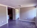 An open-concept living room features a neutral color palette and seamless transition into other spaces at 2634 E Greenbriar Rd, Statesville, NC 28625