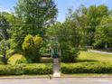 An aerial perspective of a home surrounded by mature trees, lush landscaping, and a well-maintained lawn at 304 Miller Ave, Salisbury, NC 28144