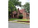 Attractive exterior view featuring brick construction, a clay tile roof, and a well maintained lawn at 324 N 5Th St, Albemarle, NC 28001