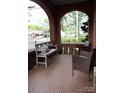 Inviting front porch featuring decorative tile, an archway, and comfortable seating furniture at 324 N 5Th St, Albemarle, NC 28001