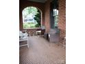 Inviting brick porch offering a cozy seating area with tiled flooring and an open view at 324 N 5Th St, Albemarle, NC 28001